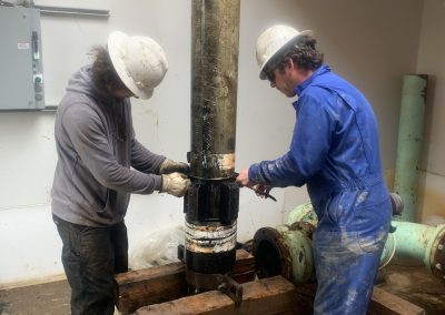 Workers Drilling a Well